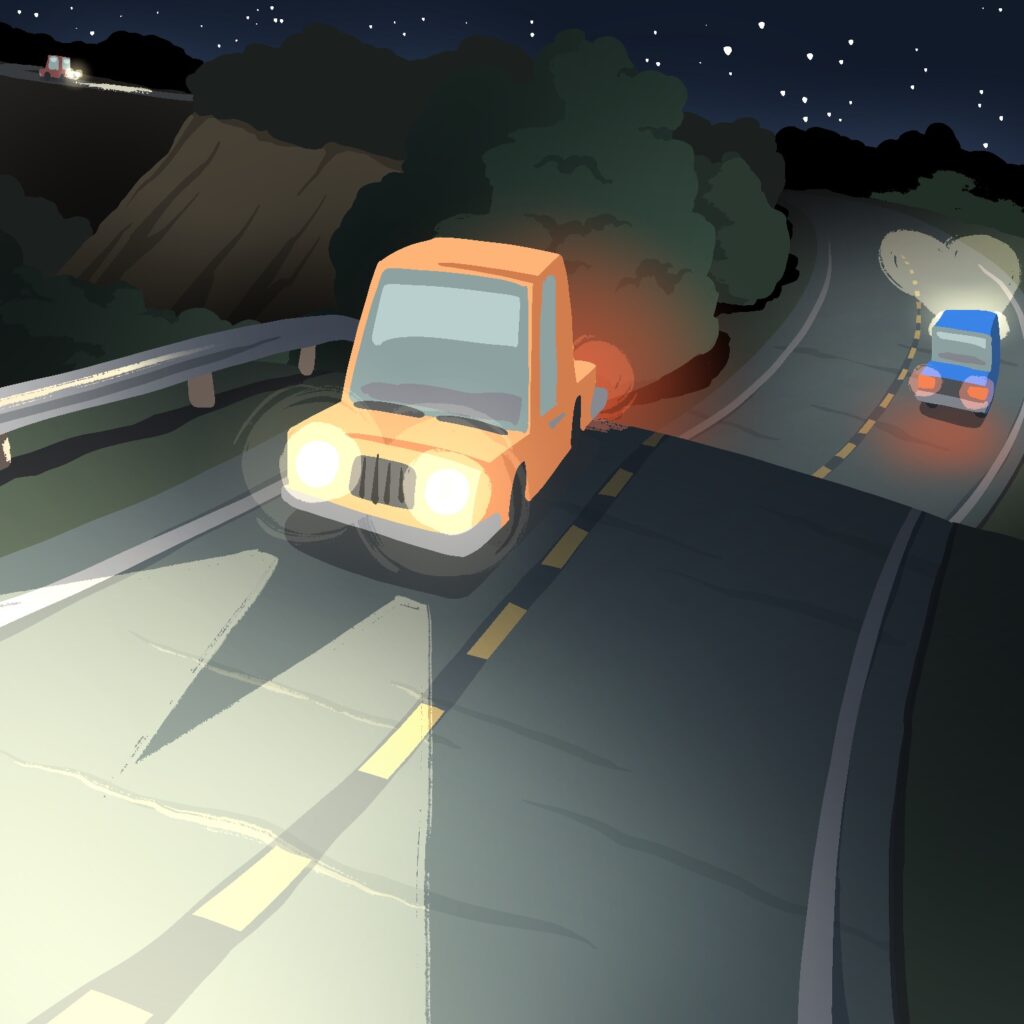 An illustration of a ridged road curving off into the distance, into the dark of night. The road has a few cars driving on it and one is close to the viewer, with headlights shining down the road going just off the edge of the image. The road is lined with bushes and trees, and a guardrail in front of a ravine to the left. The cars are stylized, with stubby bodies and tall cabs. The car closest to the viewer is orange. The next car back, just down the ridge, is blue and driving in the opposite direction. The third car is red and can be seen way in the distance, heading down the road toward the viewer. The road has bumps in it and is split by a dotted yellow line down the middle. The sky in the back is dark, with small dots of stars scattered around.